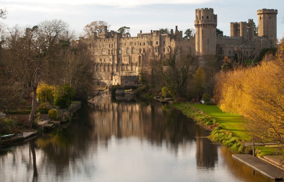 View to 12th century medieval Warwick castle seen along River Avon