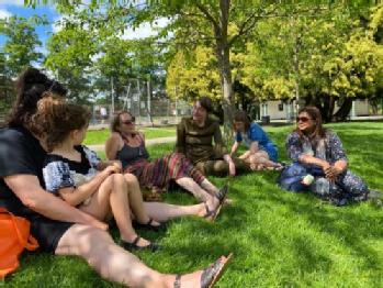 A group of women sitting in a park