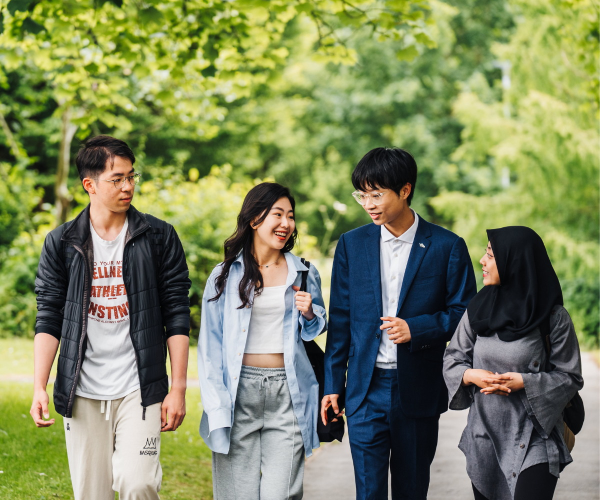 four students walking and talking