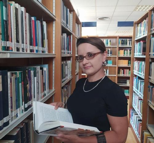 Person in library with book