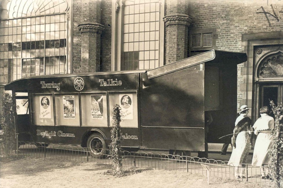Black and white photograph of a mobile cinema apparatus called 'Touring Talkie: daylight Cinema Saloon'.